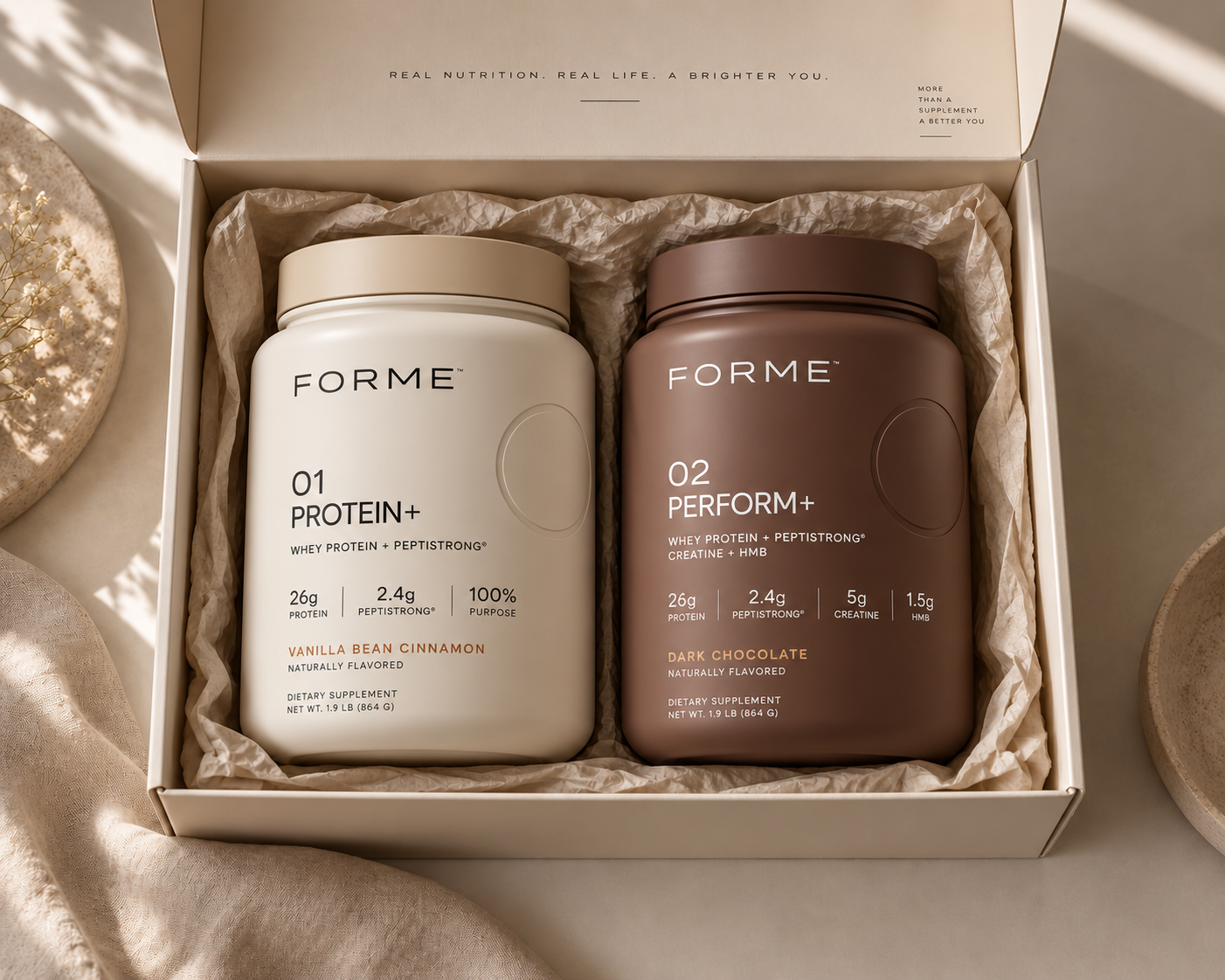 FORME 01 PROTEIN+ and FORME 02 PERFORM+ labeled tubs inside the FORME gift box